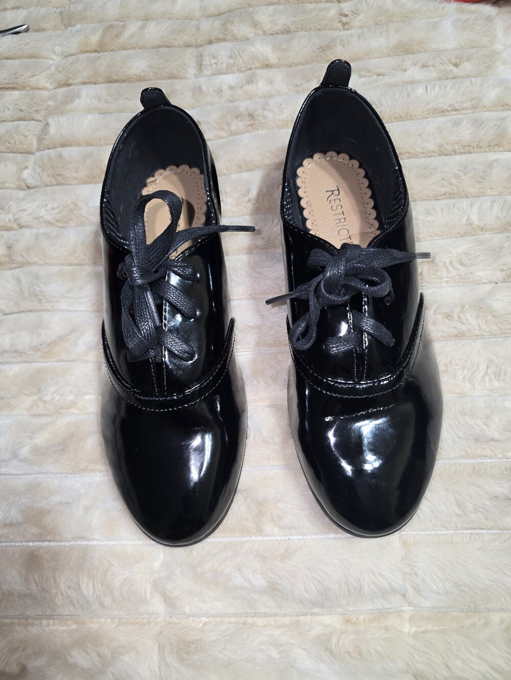 These shoes are the Restricted Women's Black Patent Leather Oxford Flats (Size 7